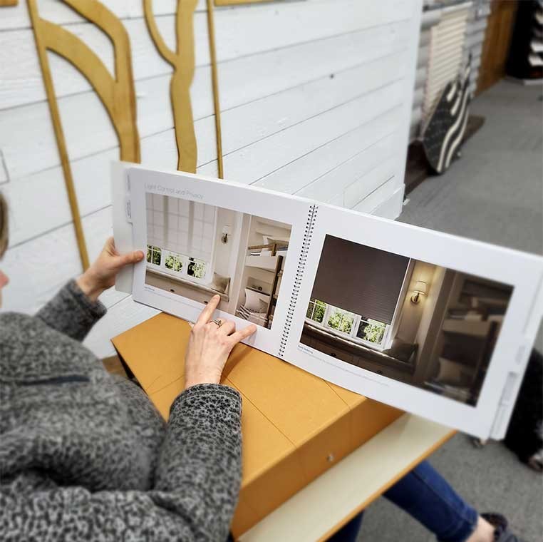 Over-the-shoulder view of a woman looking at a book